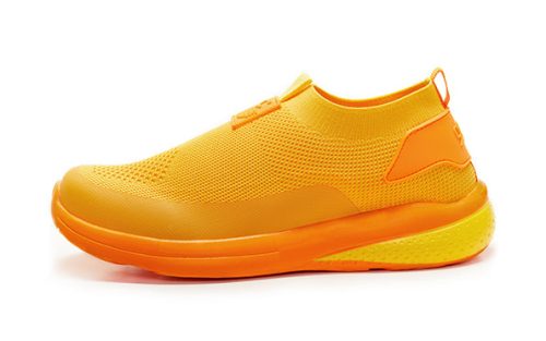 Sunset Root of Fame 990 orange slip-on sneaker with breathable mesh upper and cushioned sole.
