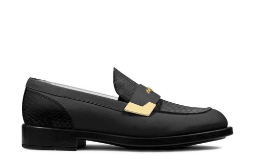 Dark Waters II Buckle Moccasin in black leather with gold buckle detail, side view.