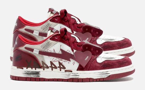 Red, grey, and white distressed suede-leather low top basketball sneakers shown in side profile on product page.