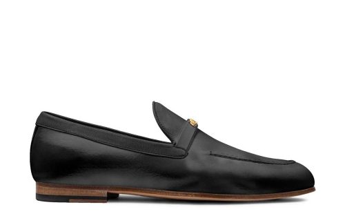 Firenze Polished Black Moccasin with gold accent, side view, leather upper and brown sole.