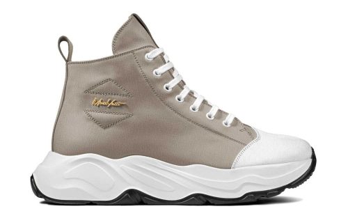 Maui Exclusive 002 sneaker in taupe with white laces, white sole, and gold branding on the side.