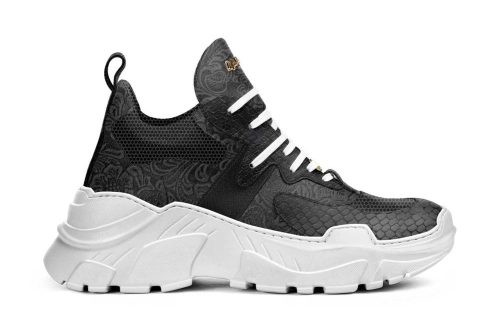 Stoke Sole Model 012 sneaker in black with white sole, side view showing textured details and laces.